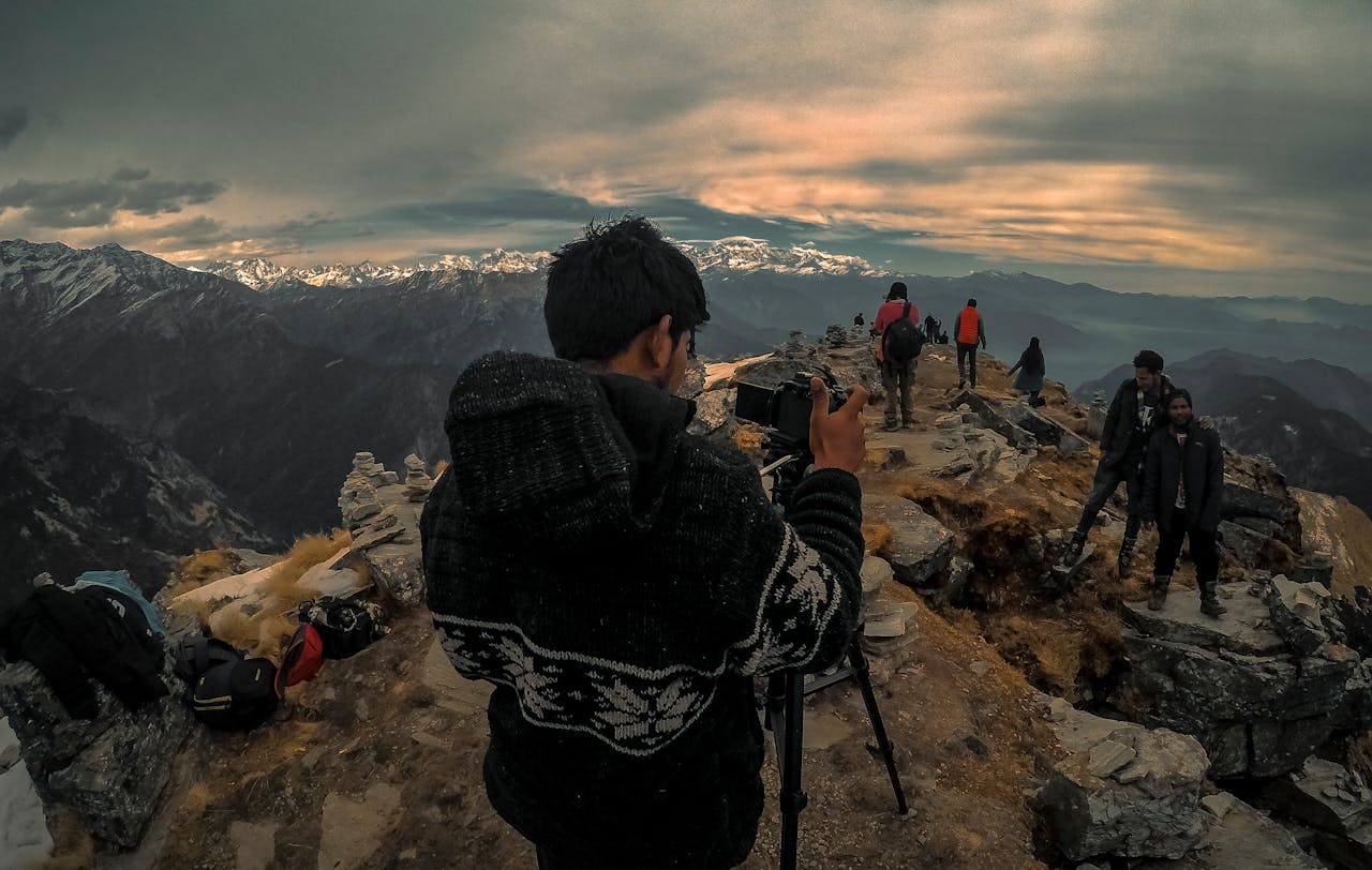 Hikers capture the breathtaking view at a mountain peak during a scenic trekking adventure.